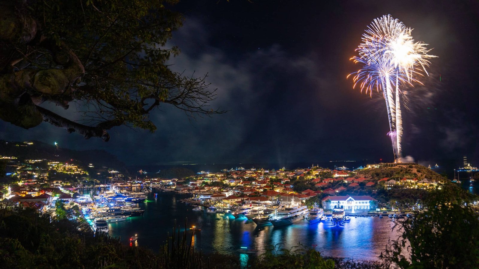 Superyachts anchored in Gustavia Harbour, St Barts, during New Year's Eve fireworks